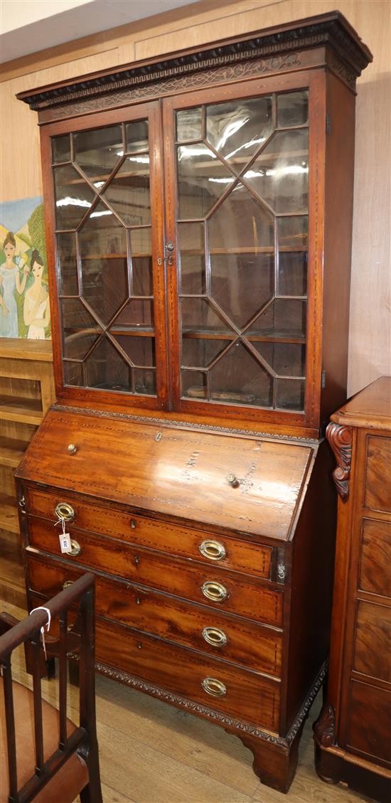 A George III mahogany bureau bookcase with later inlaid carved decoration W.106cm